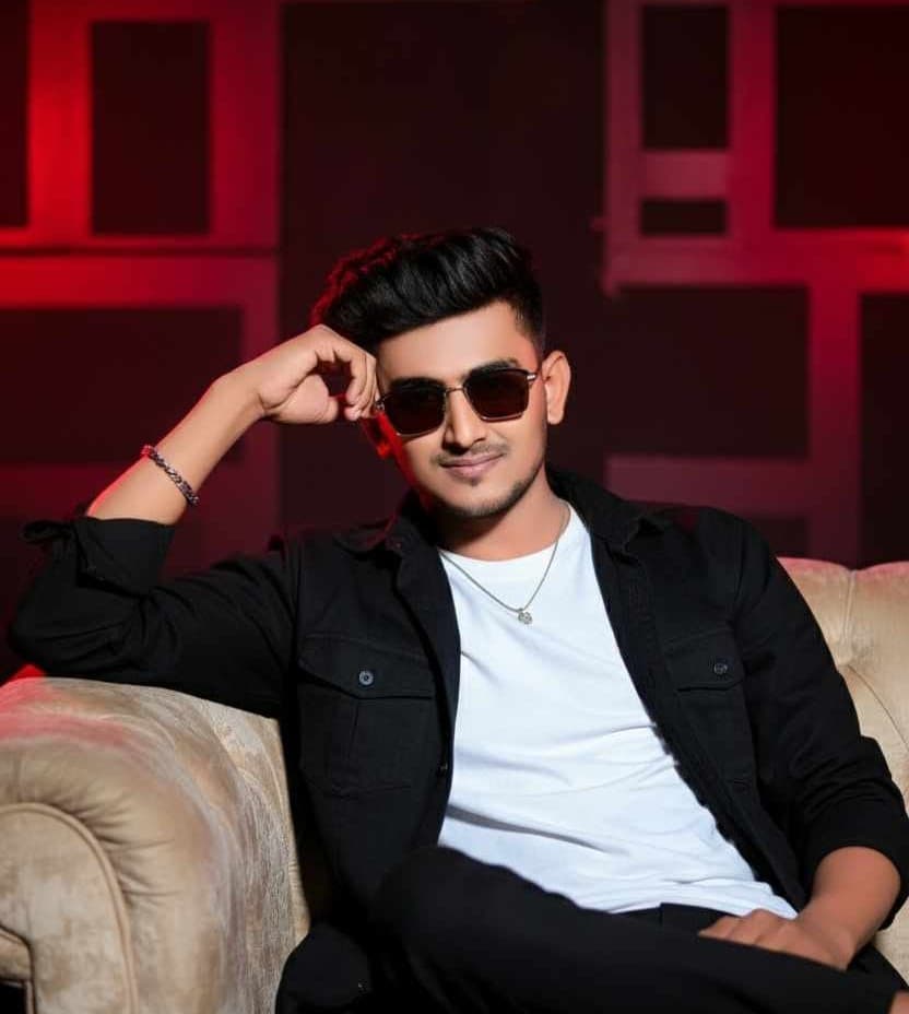A creative self-portrait of Parvess, bathed in dramatic red and blue studio light.