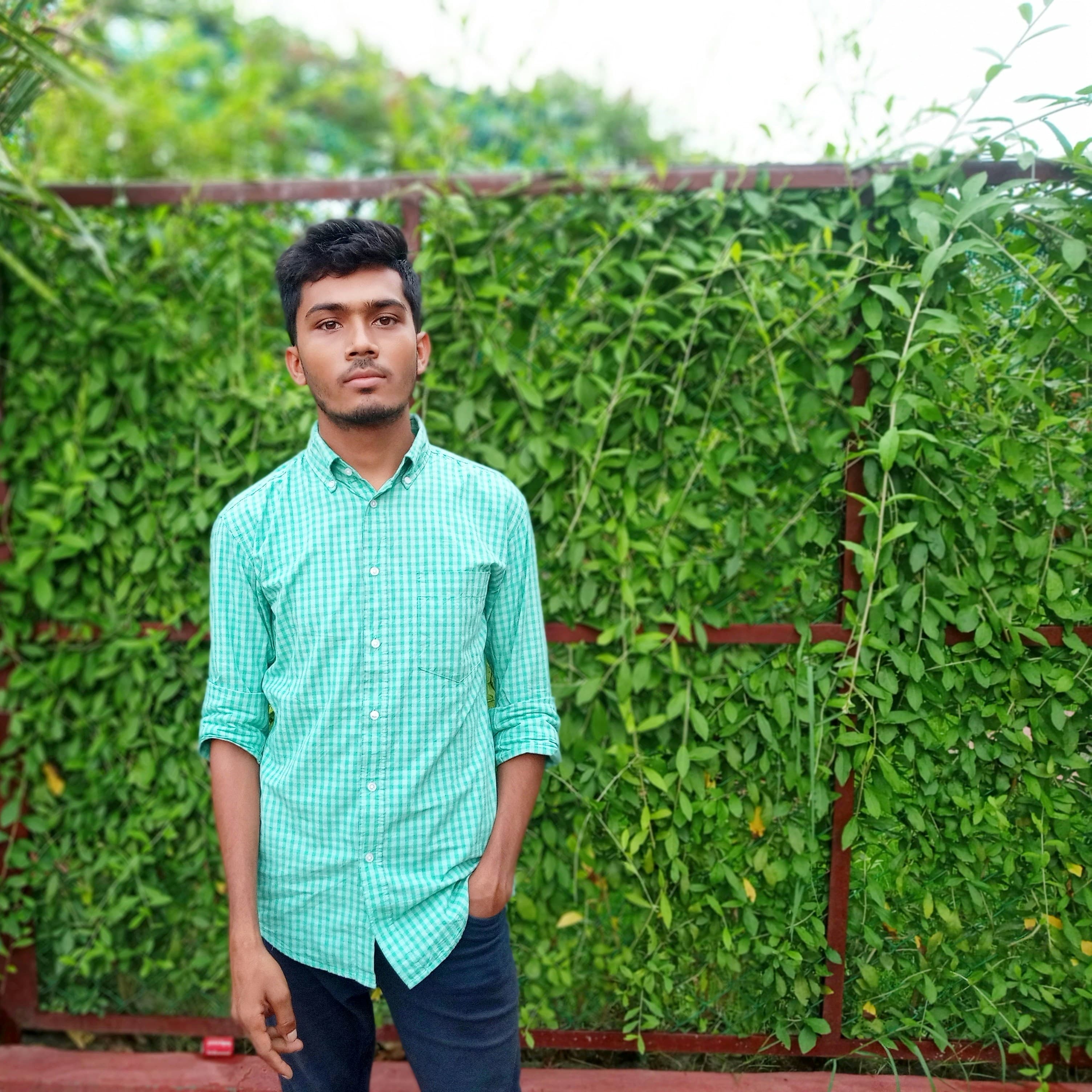 A smiling man in a casual blue shirt.