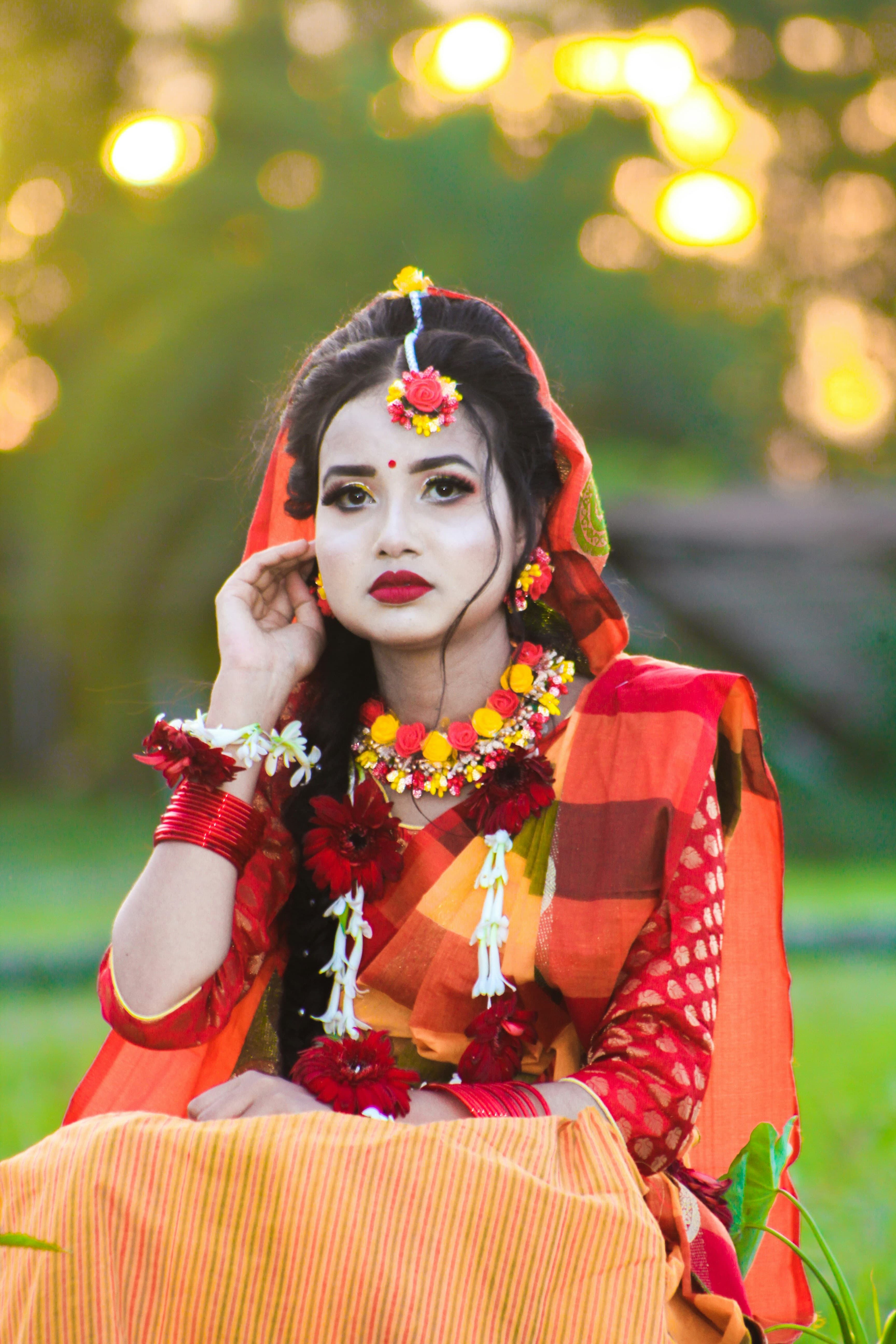 Bride in a vibrant yellow saree during a traditional ceremony.
