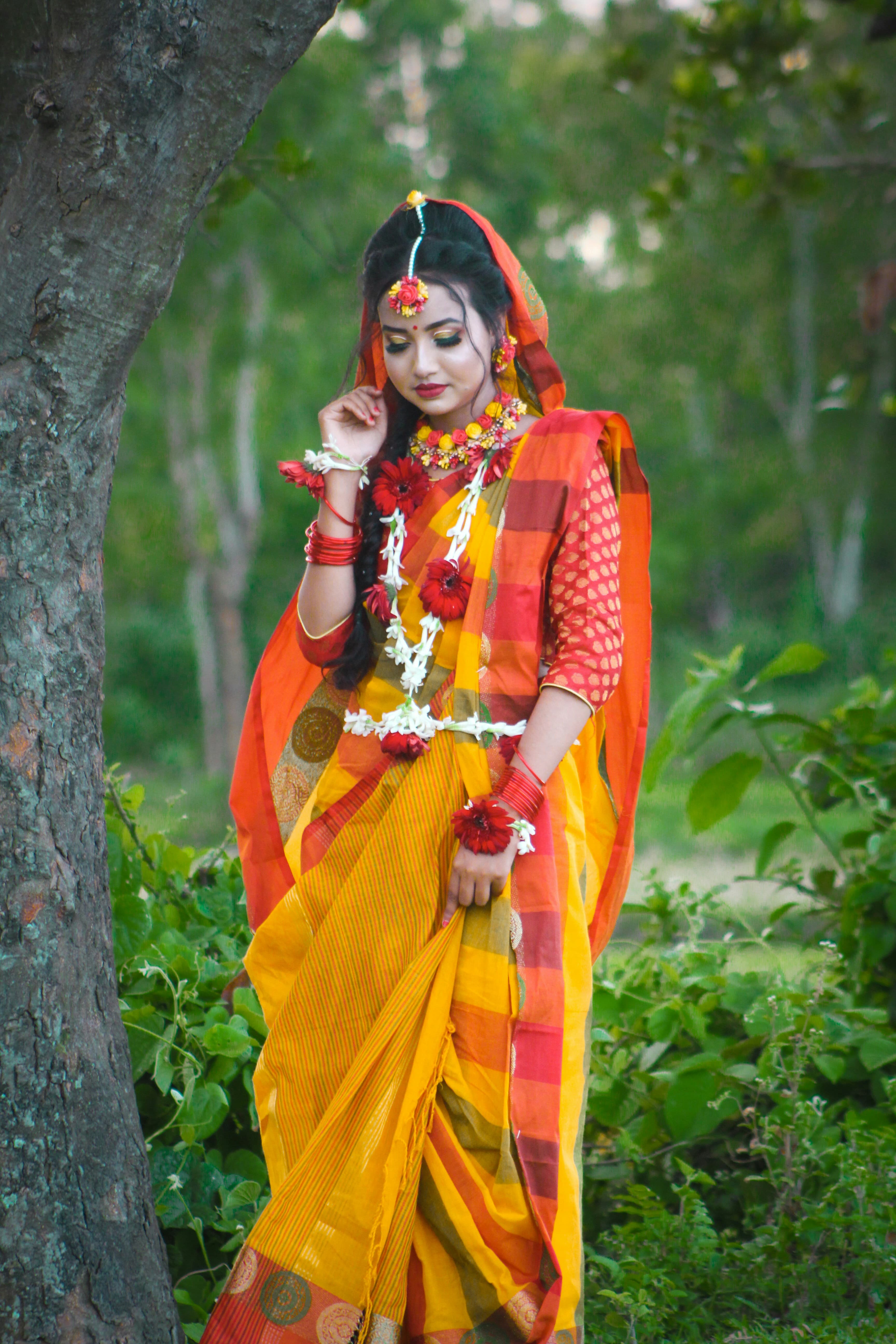 An elegant bride poses for a photo, showcasing her intricate jewelry.